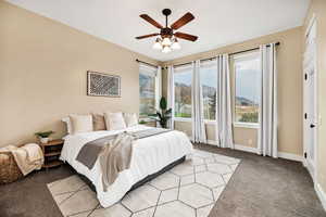 Bedroom with light colored carpet and ceiling fan