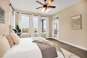 Bedroom with access to exterior, ceiling fan, and carpet floors