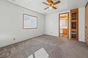 Unfurnished bedroom with carpet, ceiling fan, and a textured ceiling