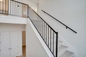 Stairs featuring wood finished floors