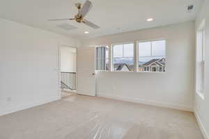 Unfurnished room with light carpet, ceiling fan, and recessed lighting