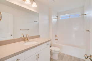 Bathroom with vanity and tub / shower combination