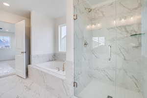 Bathroom with a marble finish shower, a bath, and marble finish flooring