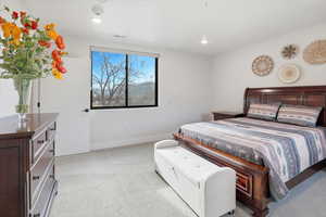 Bedroom with light carpet and recessed lighting