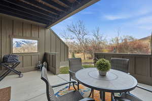 View of patio with outdoor dining space and a grill