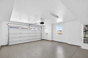 2-Car Garage featuring Epoxy Floors and Overhead Storage