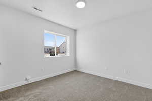 Carpeted empty room featuring baseboards