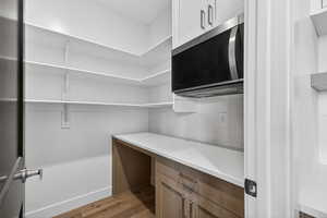 Spacious closet with light wood finished floors