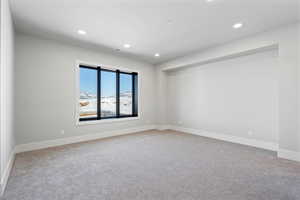 Unfurnished room featuring recessed lighting and light carpet
