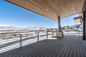 Snow covered deck with a mountain view