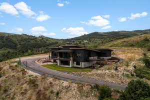 View of front of property with a balcony and a mountain view