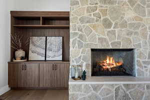Detailed view of wood finished floors and a fireplace