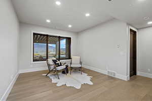 Living area featuring light wood-style floors, recessed lighting, and a mountain view