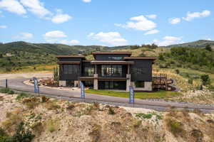 Back of house featuring a mountain view and a chimney