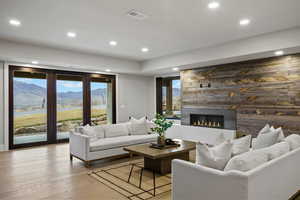 Living area featuring a mountain view, wood finished floors, a large fireplace, and recessed lighting
