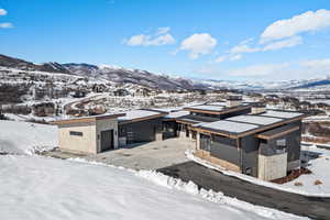 Snowy aerial view featuring a mountain view