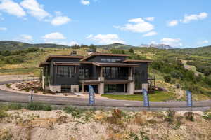 View of front of home with a mountain view and a chimney