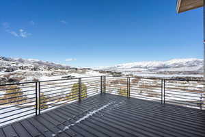 Snow covered deck featuring a mountain view
