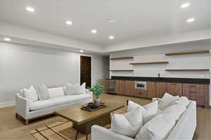Living room with recessed lighting, light wood-type flooring, and beverage cooler