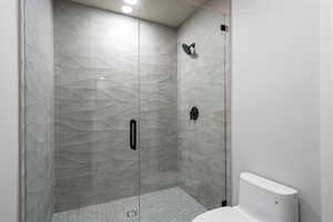 Full bath with a shower stall and toilet