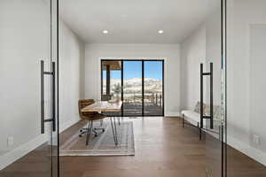 Office featuring a mountain view, recessed lighting, and wood finished floors