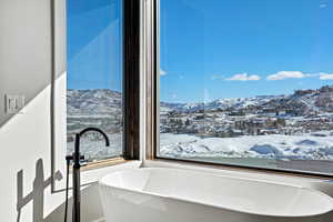 Bathroom featuring a freestanding tub and a mountain view