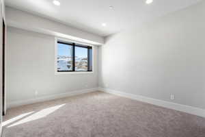 Carpeted spare room featuring recessed lighting