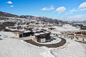 Snowy aerial view featuring a mountain view