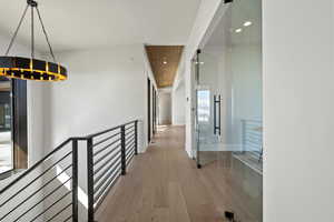 Corridor featuring an upstairs landing, recessed lighting, and wood finished floors