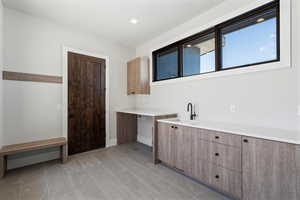 Bar area featuring modern cabinets and recessed lighting