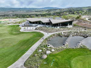 Drone / aerial view of a mountain backdrop and a golf course