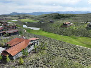 Bird's eye view of a golf club and a water and mountain view