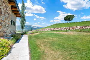 View of green lawn featuring a mountain view