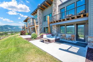 Patio / terrace with a mountain view, a lawn, a patio, and an outdoor living space