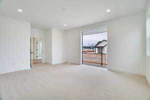Spare room with light colored carpet and recessed lighting