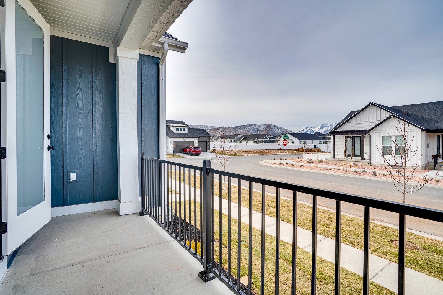 Covered porch featuring a residential view