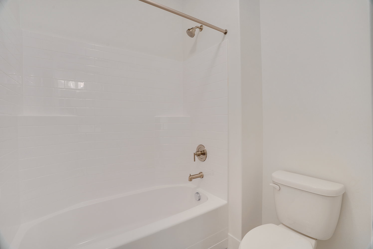 Full bath featuring bathtub / shower combination and toilet