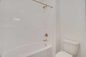 Full bath featuring bathtub / shower combination and toilet