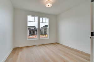 Empty room featuring light wood-type flooring and baseboards