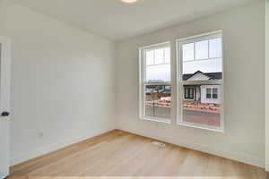 Unfurnished room featuring light wood-style flooring and baseboards