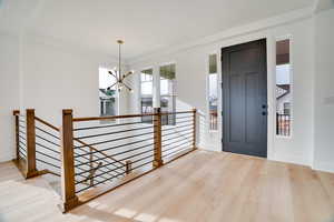Entrance foyer with a chandelier and wood finished floors