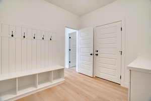 Mudroom featuring light wood finished floors