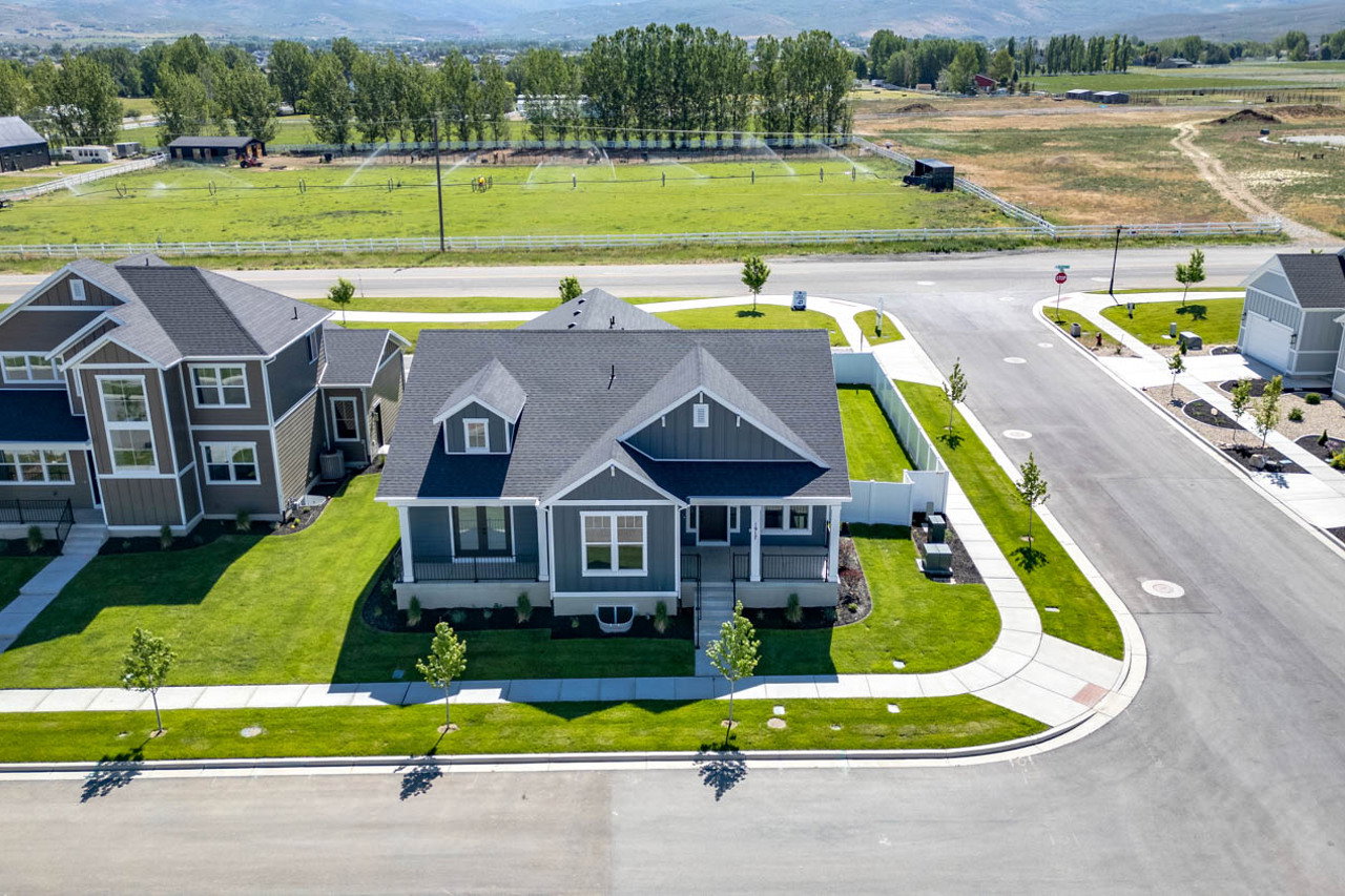 Modern residential dwelling featuring dark gray siding and white trim