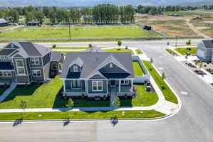 Modern residential dwelling featuring dark gray siding and white trim