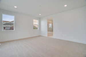 Spare room featuring light colored carpet and recessed lighting