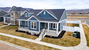 View of front facade with roof with shingles, board and batten siding, covered porch, and a mountain view