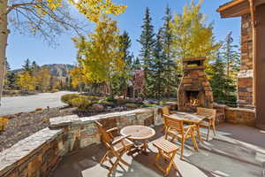 View of patio featuring an outdoor stone fireplace