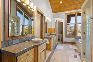 Full bathroom with inlaid floor details, wooden ceiling, two vanities, a stall shower, and recessed lighting