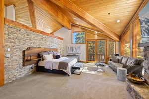 Bedroom with high vaulted ceiling, carpet flooring, a wooden ceiling with exposed beams, and access to outside