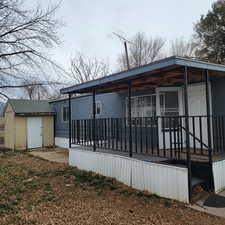 Back of property with a storage shed